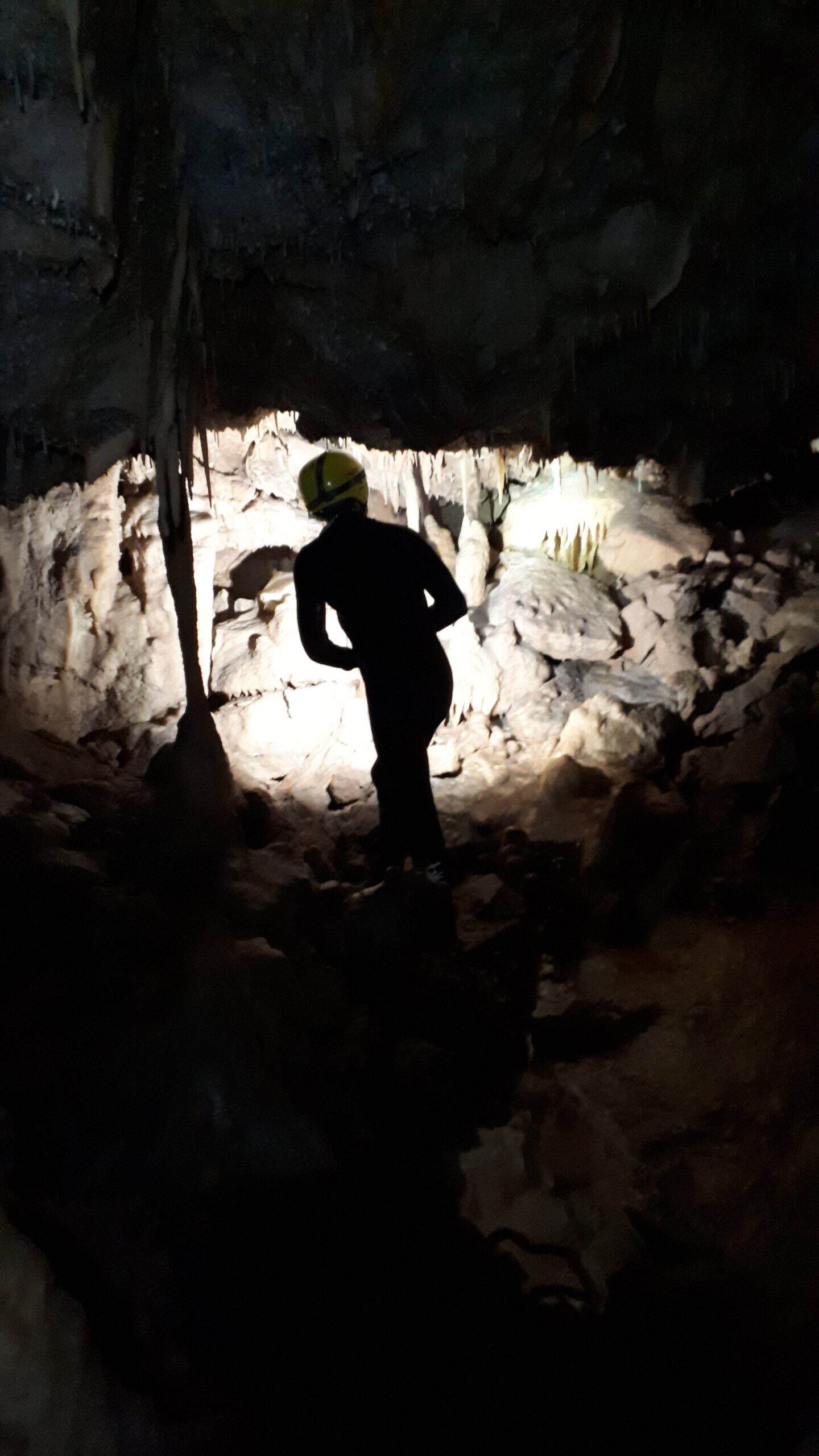 Tenby Adventure guide exploring a limestone sea cave on the South Pembrokeshire coast