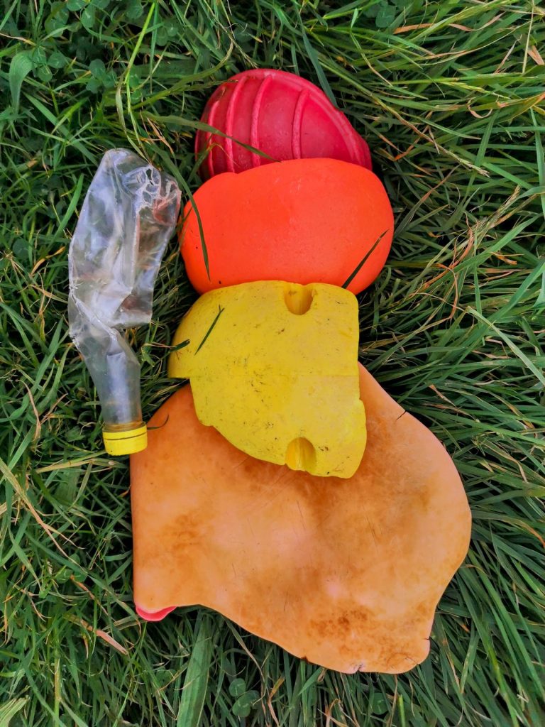 A typical Ghosteering haul: buoys, plastic sheet and a bottle recovered from the Pembrokeshire coast, laid out on grass